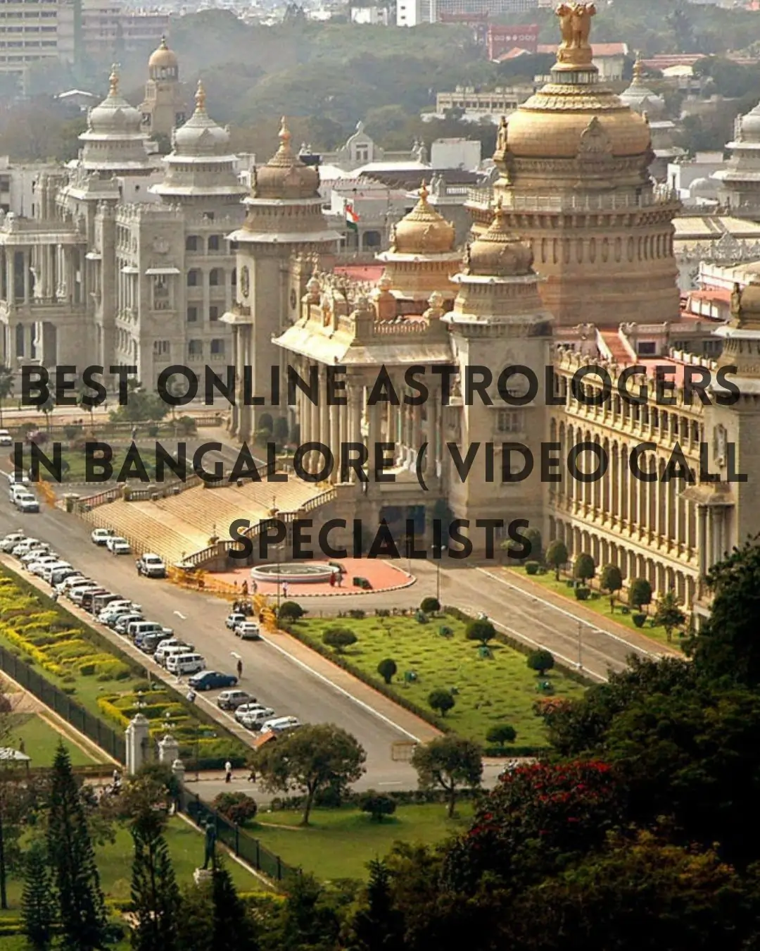 Aerial view of Vidhana Soudha in Bengaluru, domes gleaming, gardens and parked cars lining avenue.