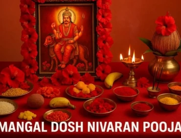Ritual setup for Mangal Dosh Nivaran Pooja with deity image, lamps, flowers, powders, offerings.