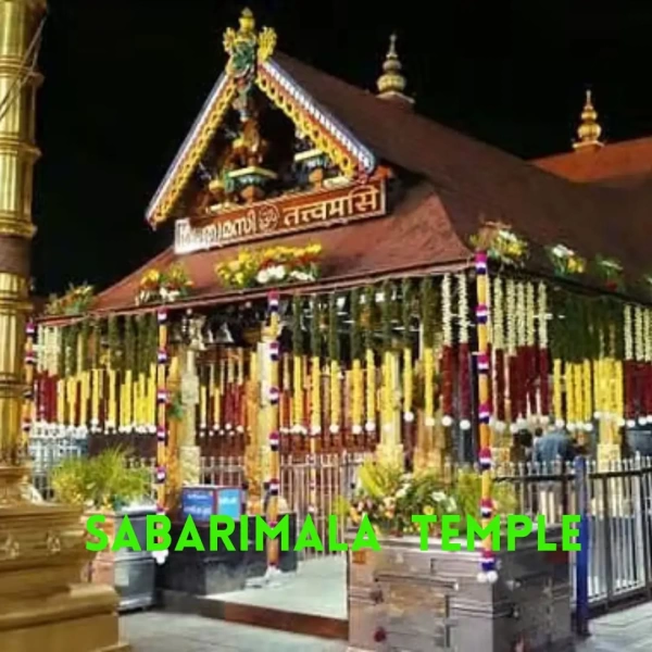 Night view of decorated Sabarimala Ayyappa temple with garlands, gold-plated roof, illuminated pillars, and pilgrims outside.